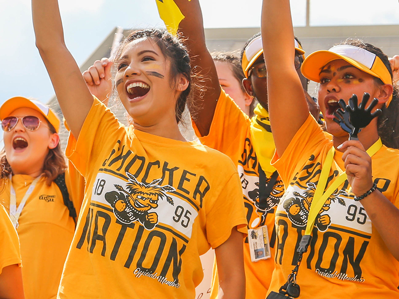 Students dressed in yellow cheer at Clash of the Colleges