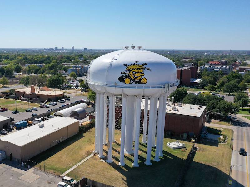 Drone photograph of campus during the day with the watertower in the foreground. 