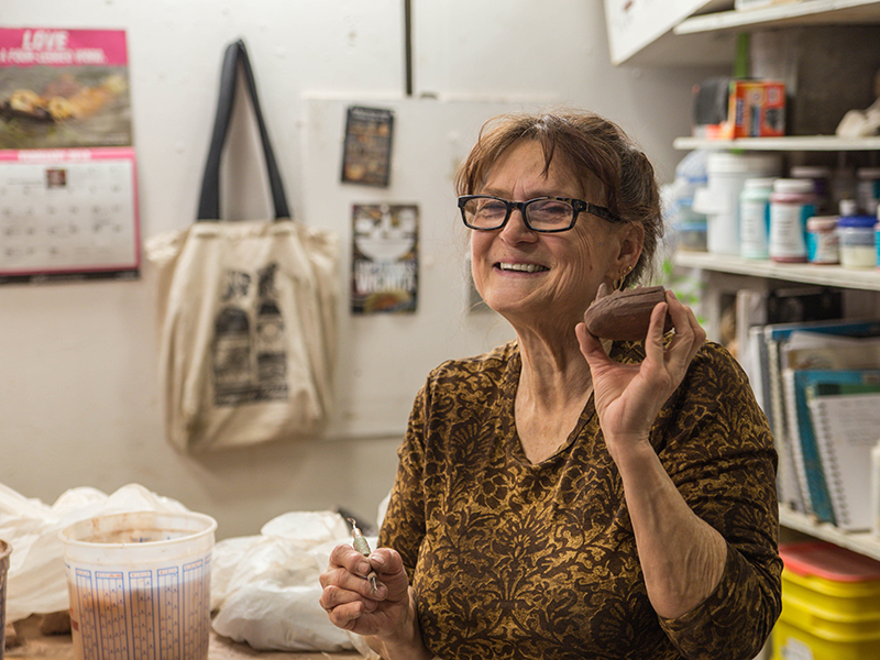 Age 60 plus adult learner working on sculpture project