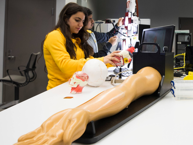 Female student working on robot arm