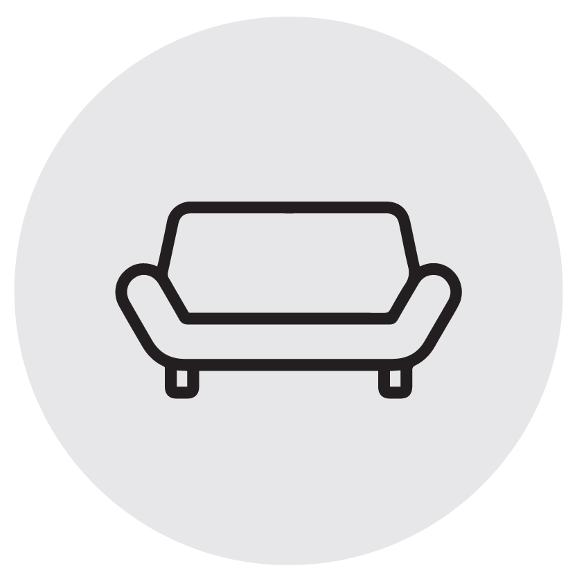 black icon of wide chair with grey background