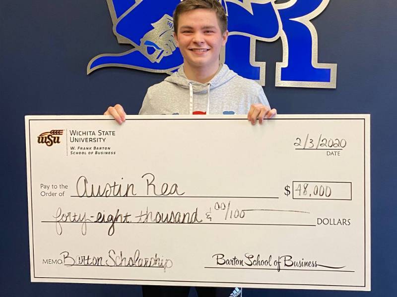 Austin Rea holding a big check