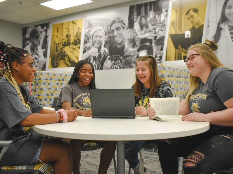 Girls sitting around a desk