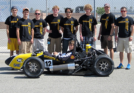 The Shocker Racing team participated in Formula SAE at Auto Club Speedway. Members from left to right are Peter Strunk, Shane Thuillez, John Bird, Nic Wentling, Tan Nguyen, Joran Matson, Adam Wiley and Nick Deneault.
