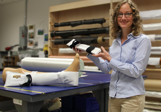 Kim Reuter, senior research engineer at WSU, shows off an innovative new splint that can be used to stabilize battlefield injuries.
