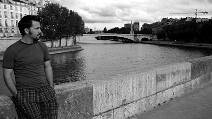 Andrew Crust, a Wichita State music student, stands behind the Notre Dame cathedral along the River Seine in France.