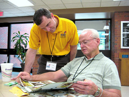 Dan Ritter, right, shows Mel Whiteside, another teacher participating in Project Lead the Way, photos of his time at WSU.