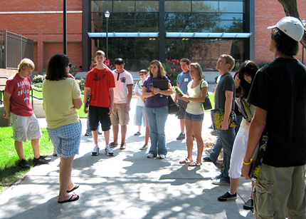 Student orientation leader Quinn Addis leads a tour of the Wichita State University campus.
