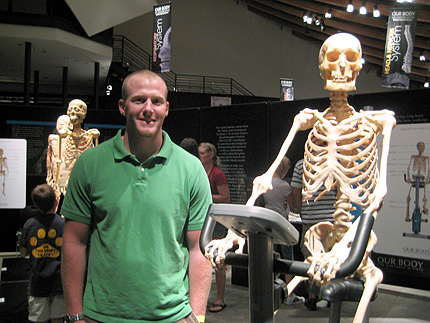 Courtney Morse stands in front of one of the exhibits at Our Bodies: The Universe Within showing at the Exploration Place