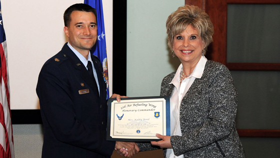 Kathy Bond, right, accepts a certificate naming her 22nd OSS honorary commander from Lt. Col. Aaron Walenga.