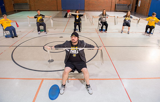 Participants perform strength training with elastic resistance bands during a WellREP class at the Linwood Senior Center.