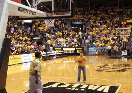 Maniac Zach Mastroly participates in a free-throw shooting contest during half-time at a basketball game.