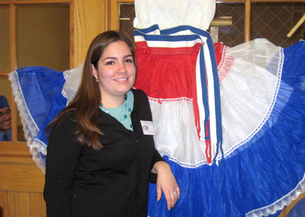Cecilia Martinez stands next to traditional Paraguayan dress at the Paraguay booth in the RSC during International Education Week, Nov. 17-22.