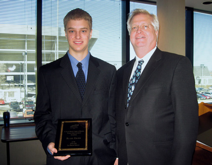 Blake Krier, left, poses with Craig Barton, brother of the late Clay Barton, for whom the Clay Barton Scholarship in Business is named after.