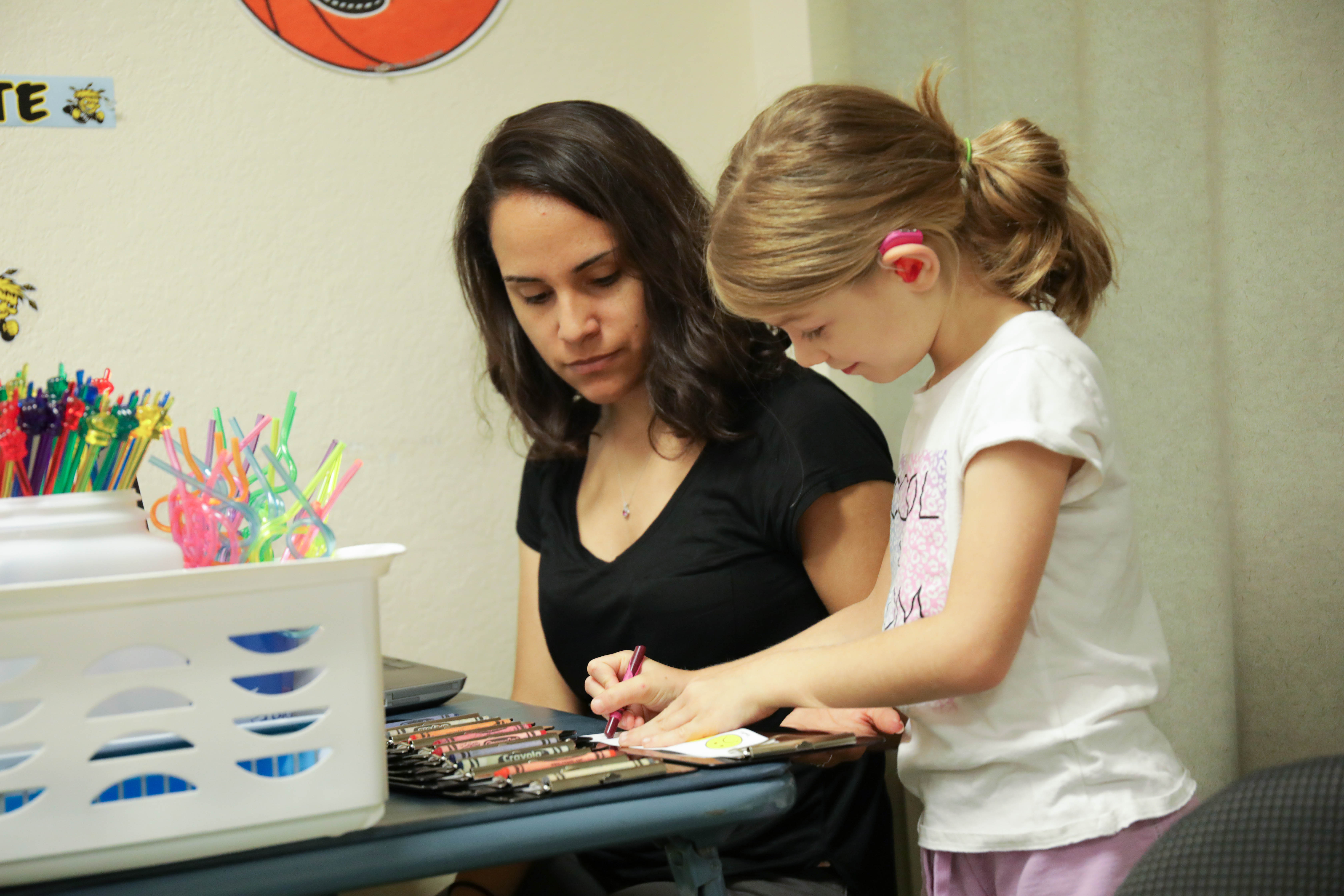 Graduate students works with child during Literacy Camp