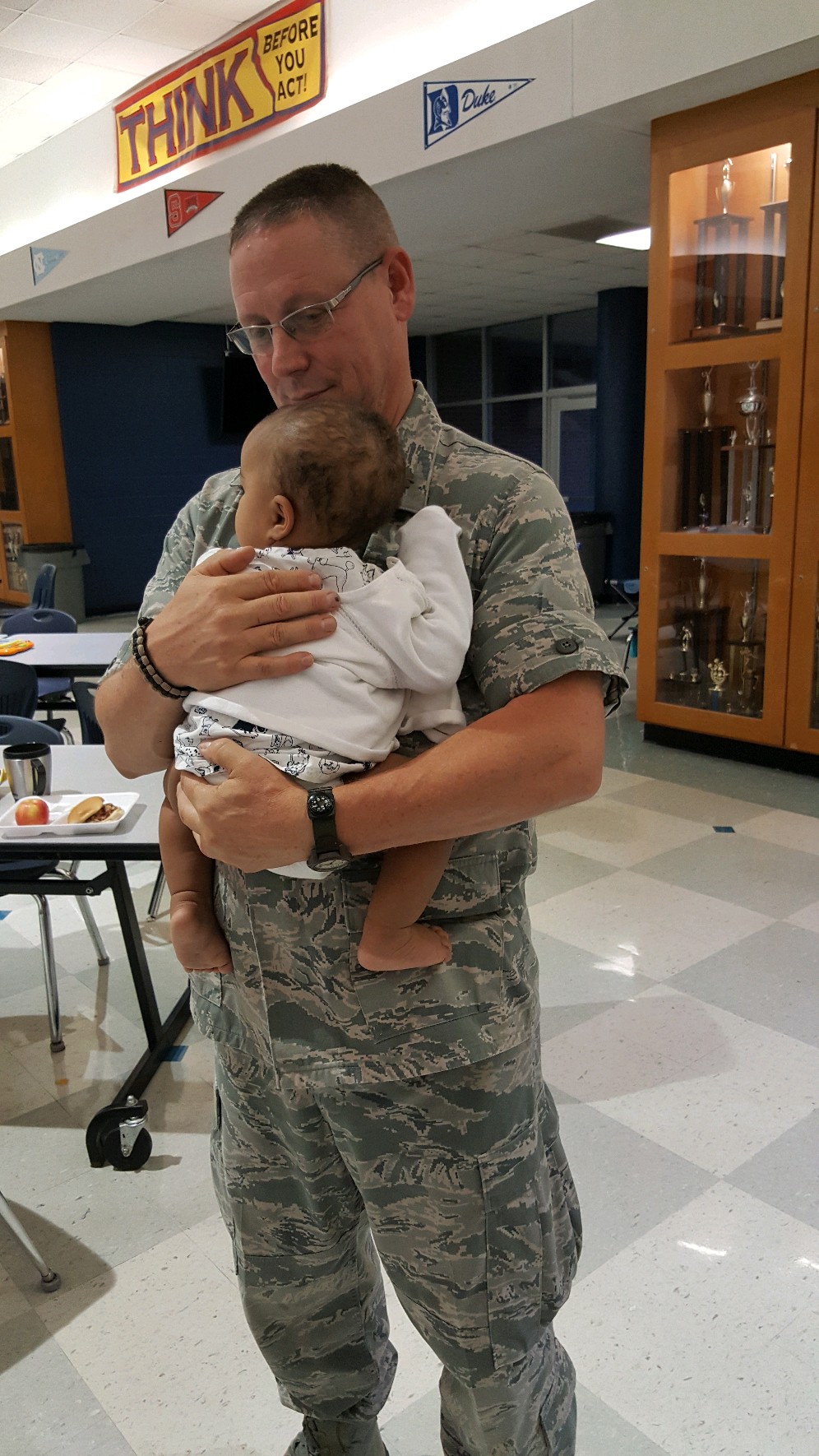 Richard Nold holds baby after Hurricane Florence hit