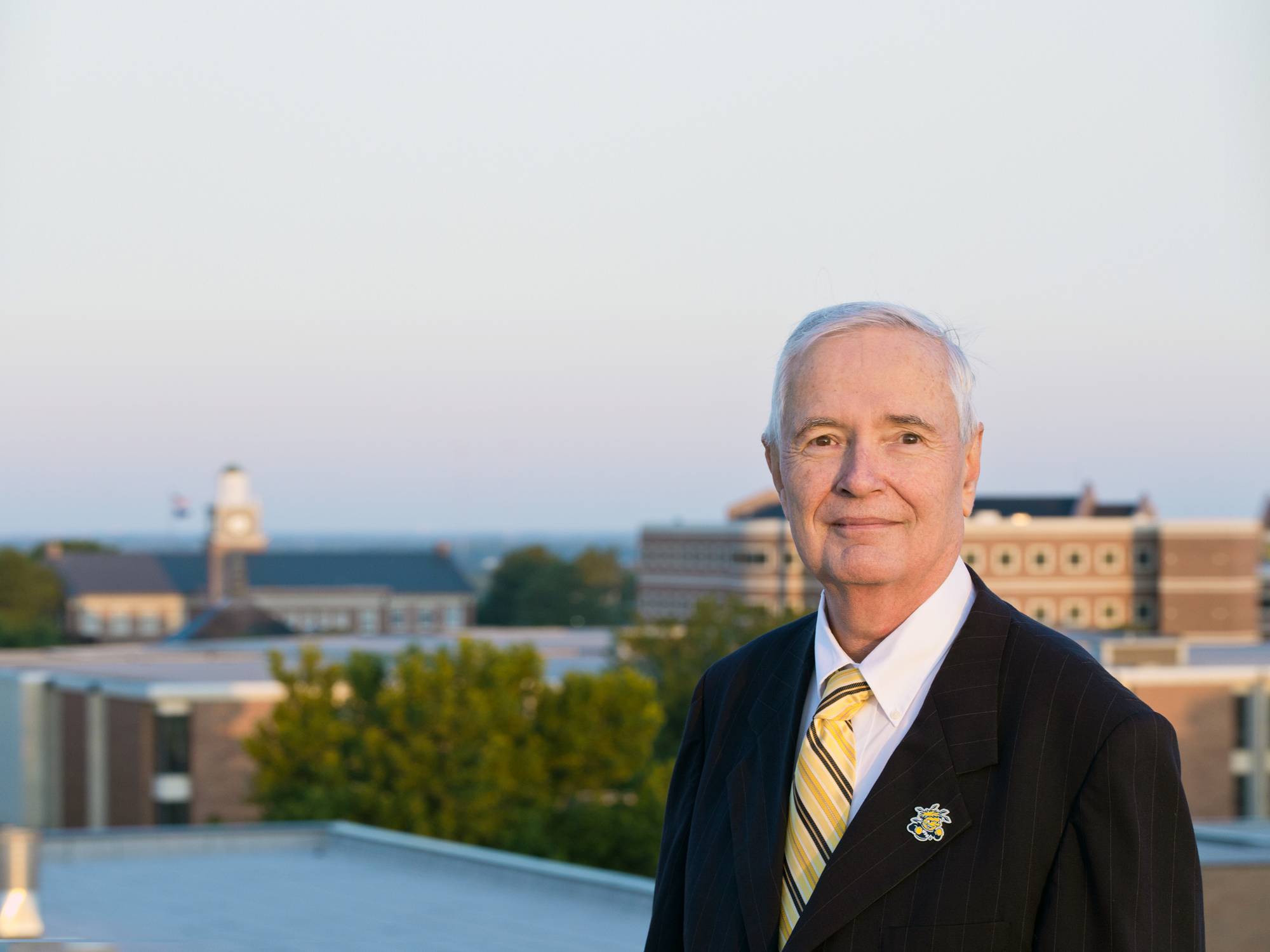 Dr. John Bardo with campus landscape.