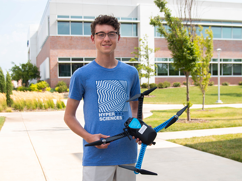 Student Spencer Lueckenoito holding a drone