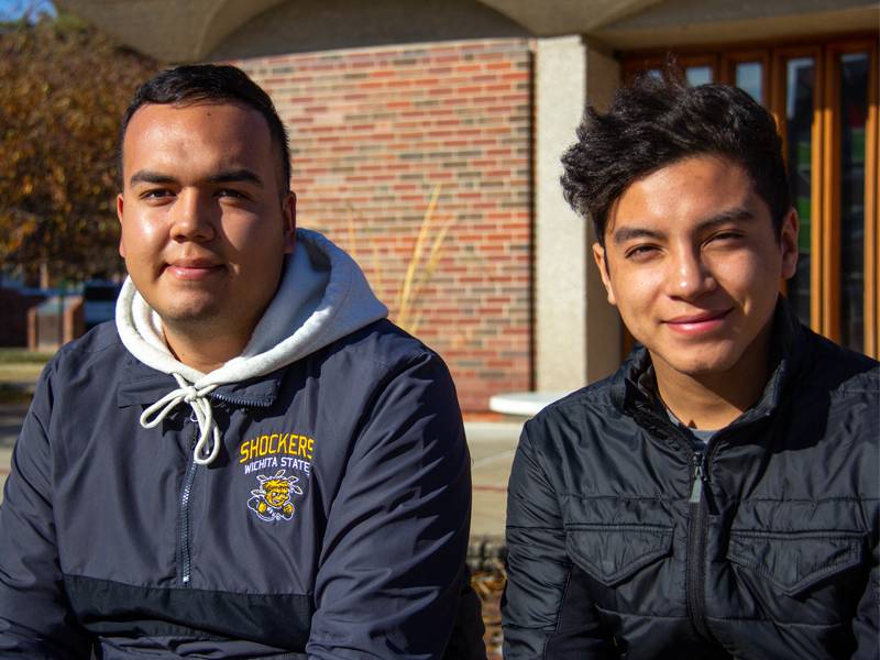 Freshmen Jonathan Lozano and Javier Martinez sit in front of Grace Memorial Chapel