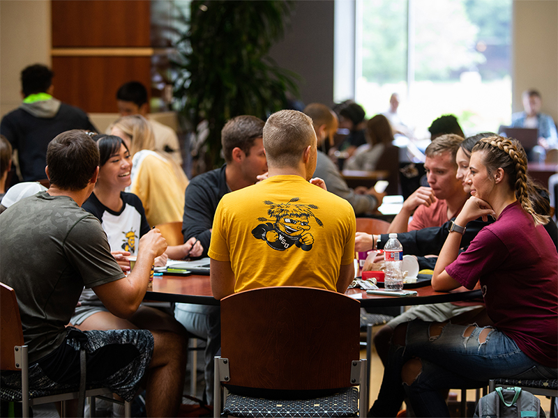 Students talking at a table in the RSC