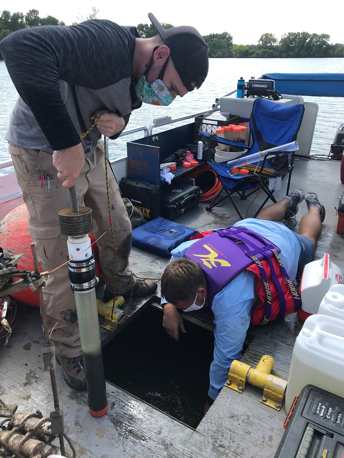 Dr. Brian Bohnsack (blue shirt) collects blue-green algae samples from Marion Reservoir. 