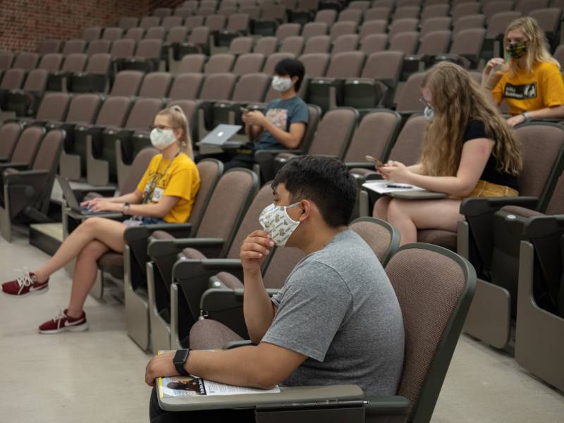 Students attend class wearing face coverings.