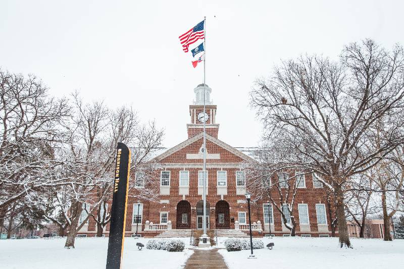 Photo of Morrison Hall during winter with snow on the ground. 