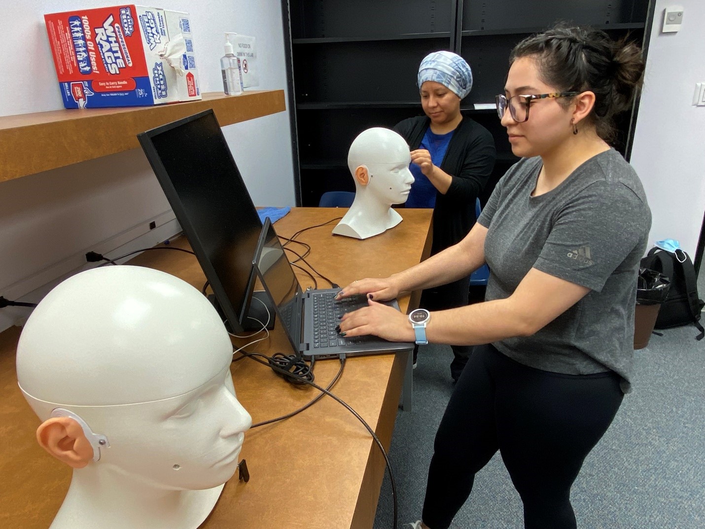 Audiology student works on simulation manikin