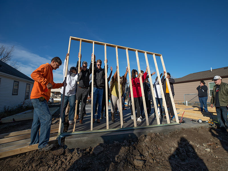 Photo featuring President Rick Muma and First Gentleman Rick Case raising wall at Habitat for Humanity event.