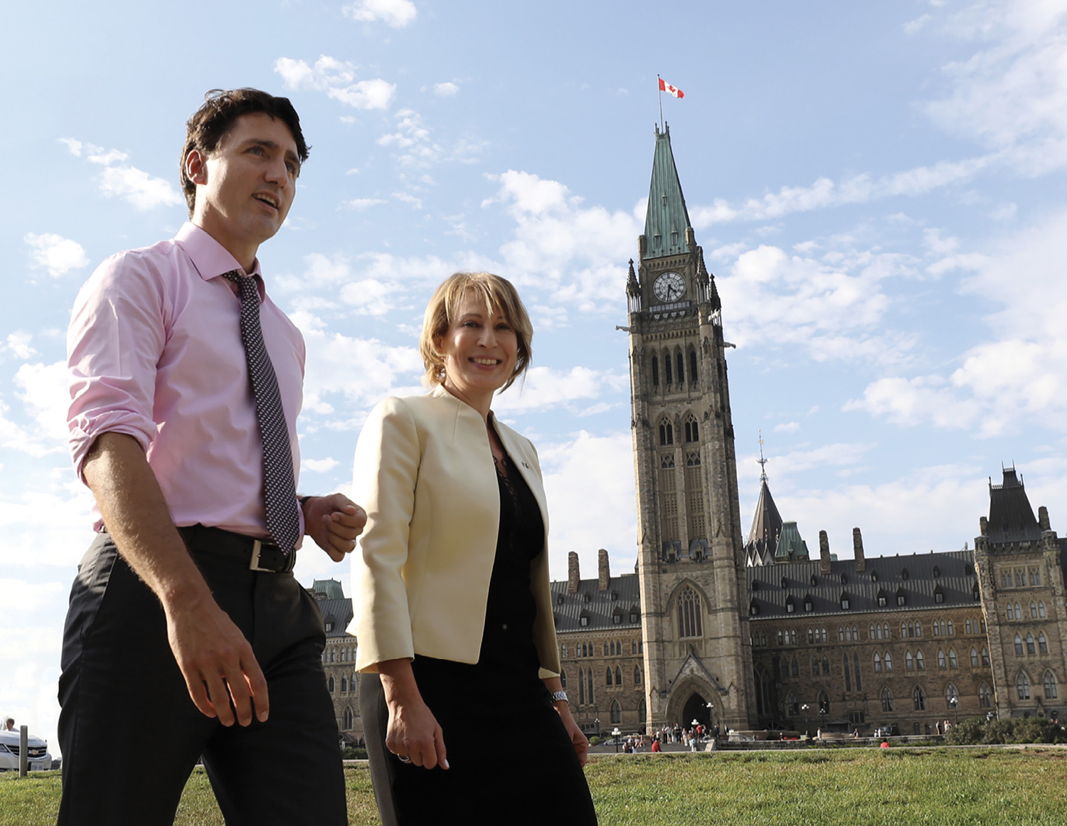 1977 graduate Mona Nemer (right) walks with Candian Prime Minister Justin Trudeau.