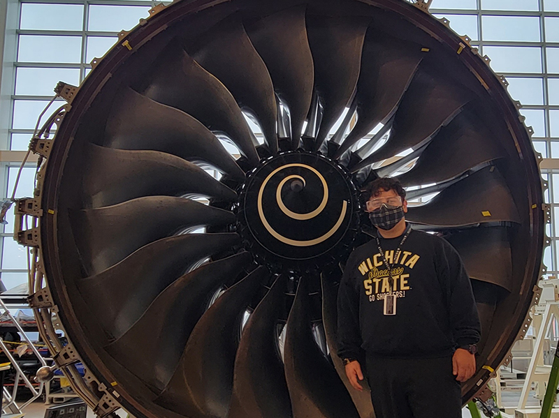 Anllir Ramirez-Tenorio in front of a piece of equipment