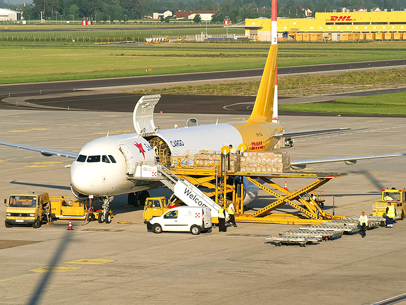 A DHL plane gets loaded with cargo. 