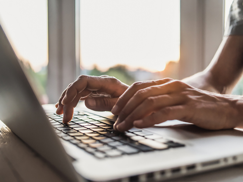 Image of hands typing on keyboard