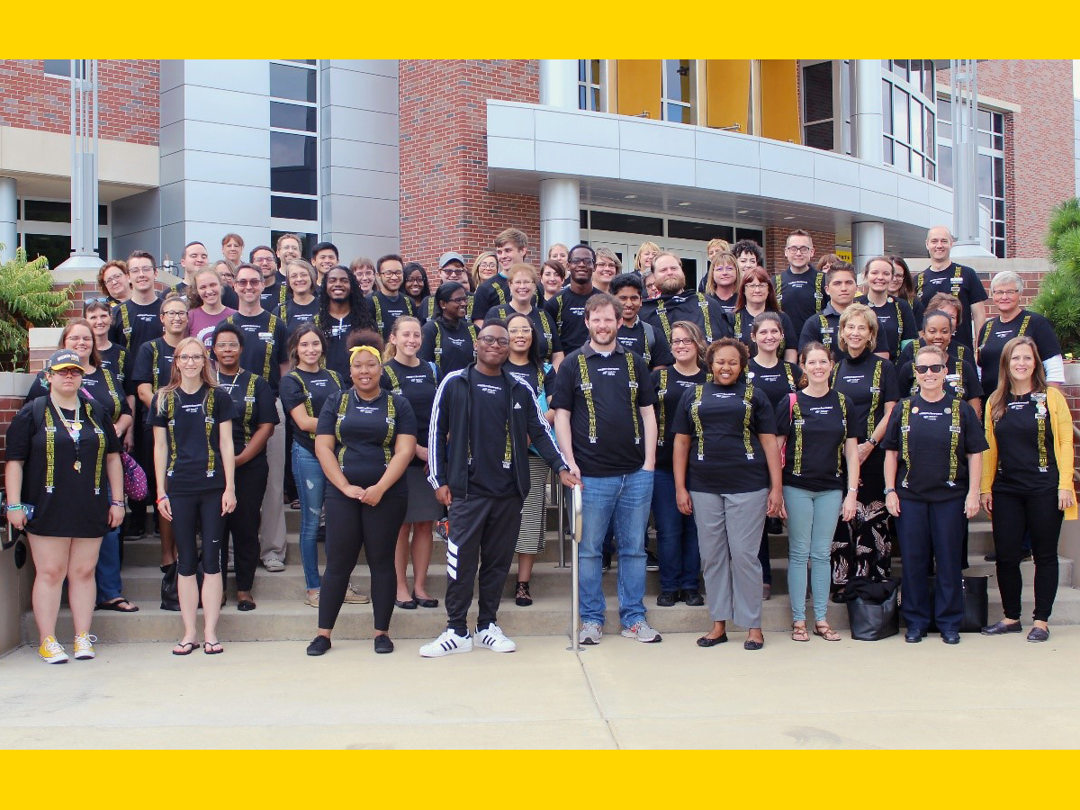 Image of members of Counseling and Prevention Services members posing for group photo outside of the Rhatigan Student Center.