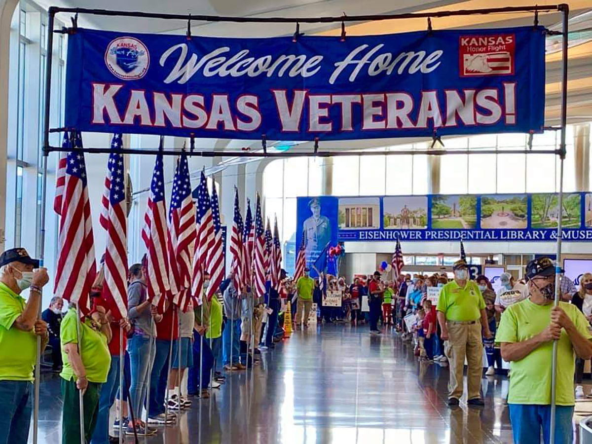Image of veterans holding flags at Eisenhower airport.