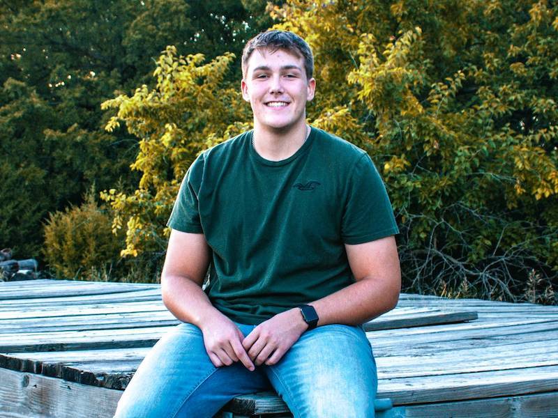 Kyan Caudillo sitting on a dock