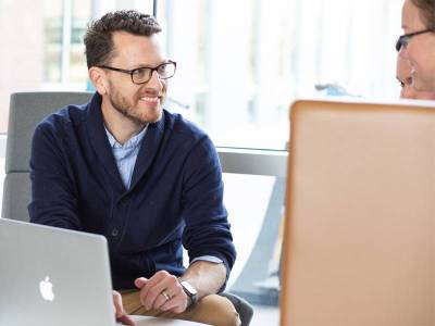 Employees discussing a presentation they will give