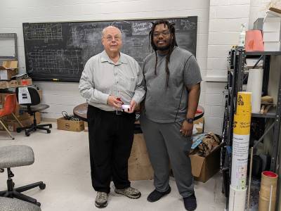 Nick Solomey and Tyler Nolan with the detector they are studying