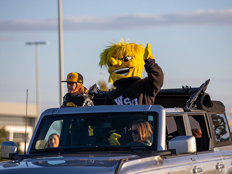 2023 Shocktoberfest parade with Wu waving from a car. 
