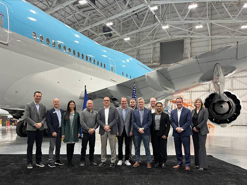 WSU and other officials standing in front of an airplane