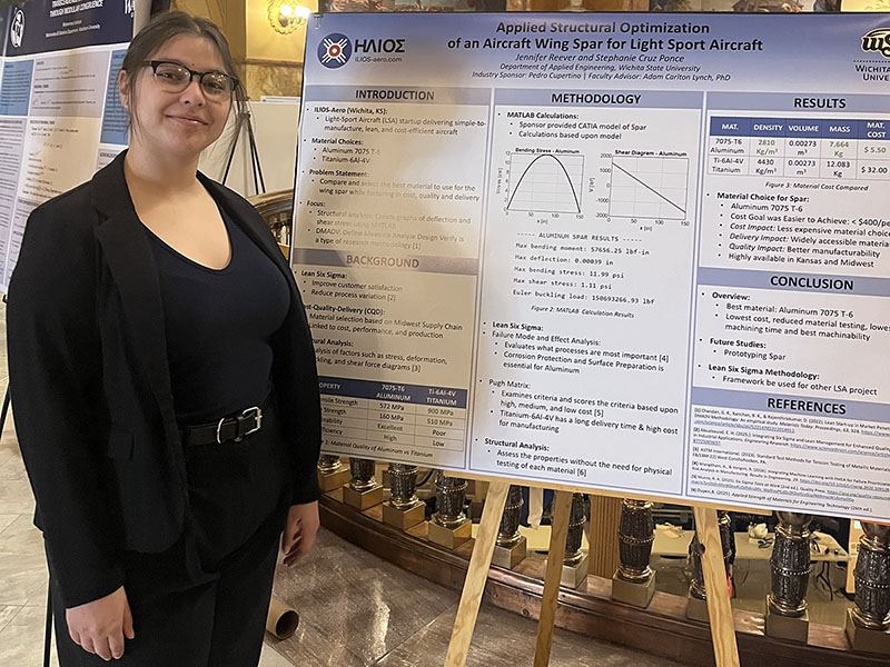 Stephanie Cruz Ponce poses in front of her research poster at the Kansas state capitol