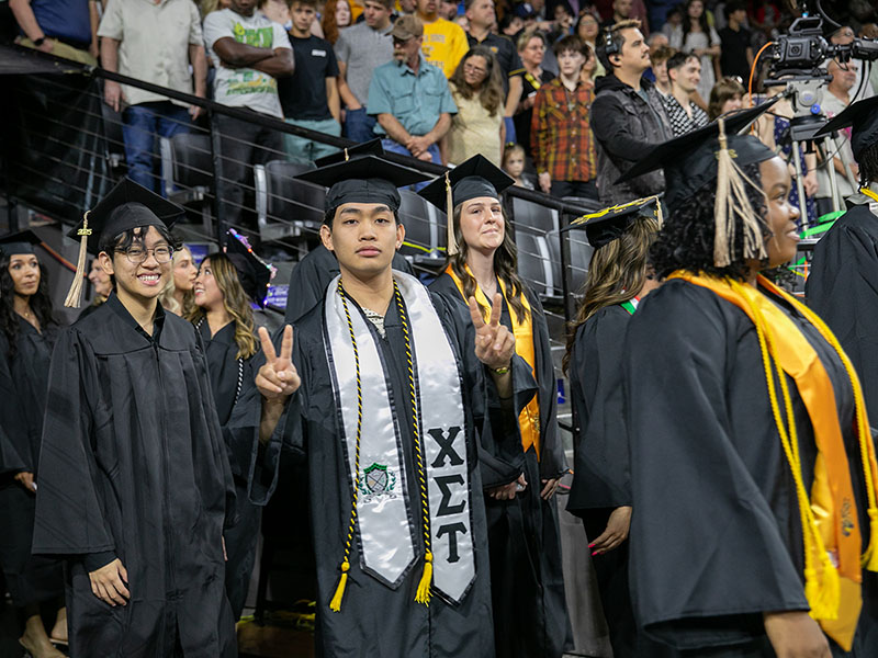Graduates line up to celebrate commencement at Wichita State University's Koch Arena. 