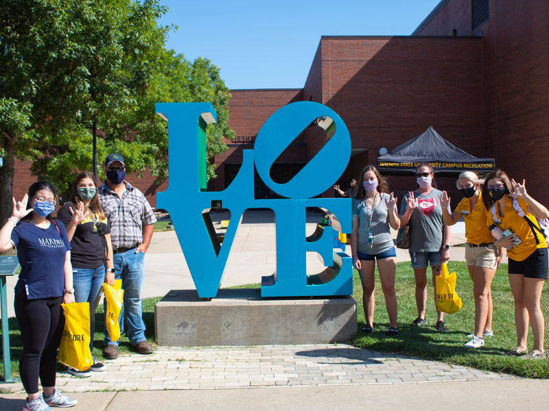 Students standing by a statue