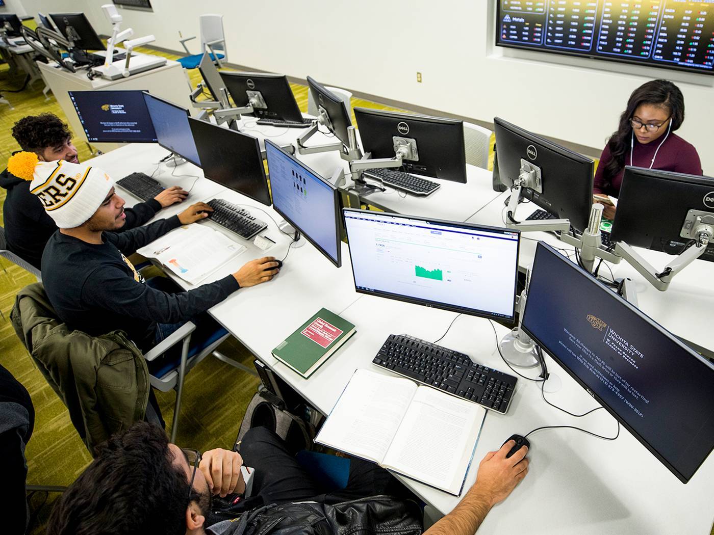 Business students attend class in the Koch Global Trading Center