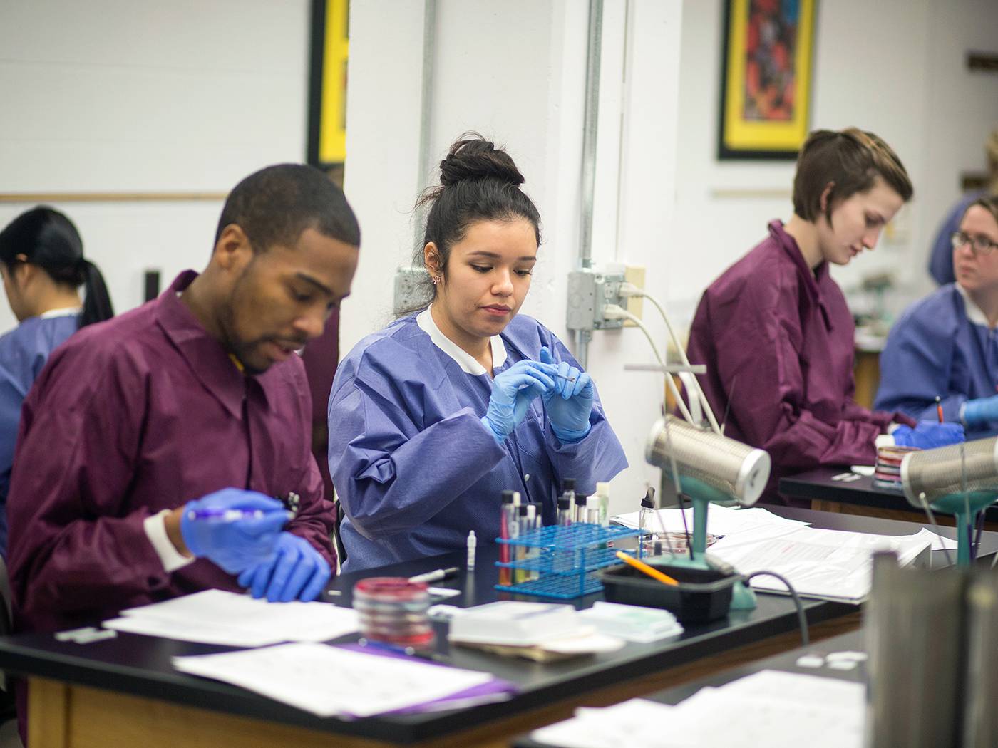 Health Professions students in clinic wearing scrubs