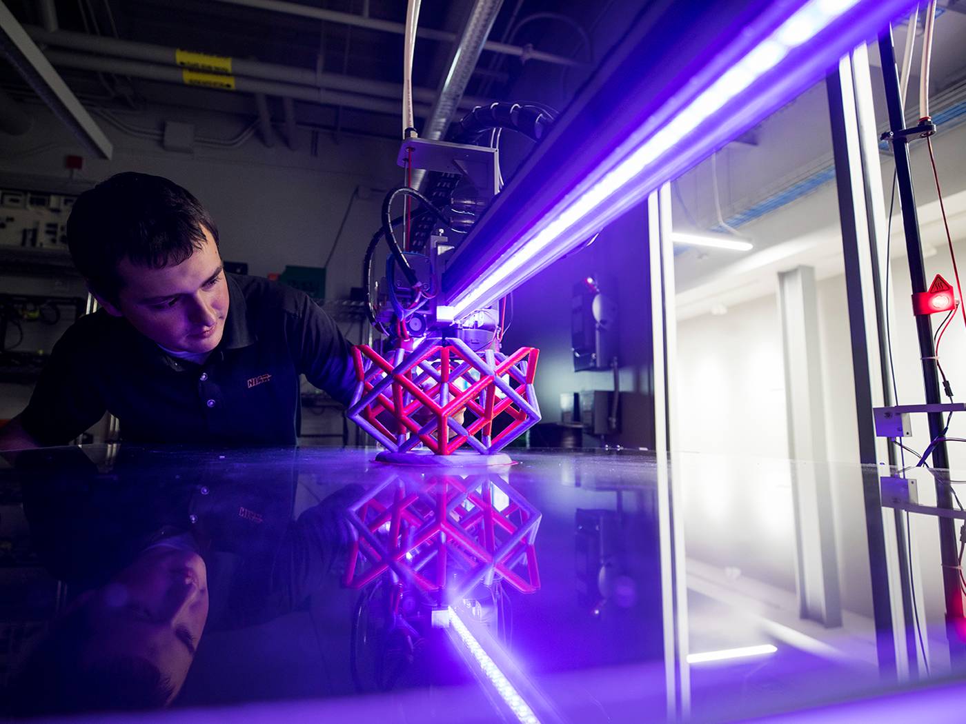 Engineering student examining a 3D printed prototype