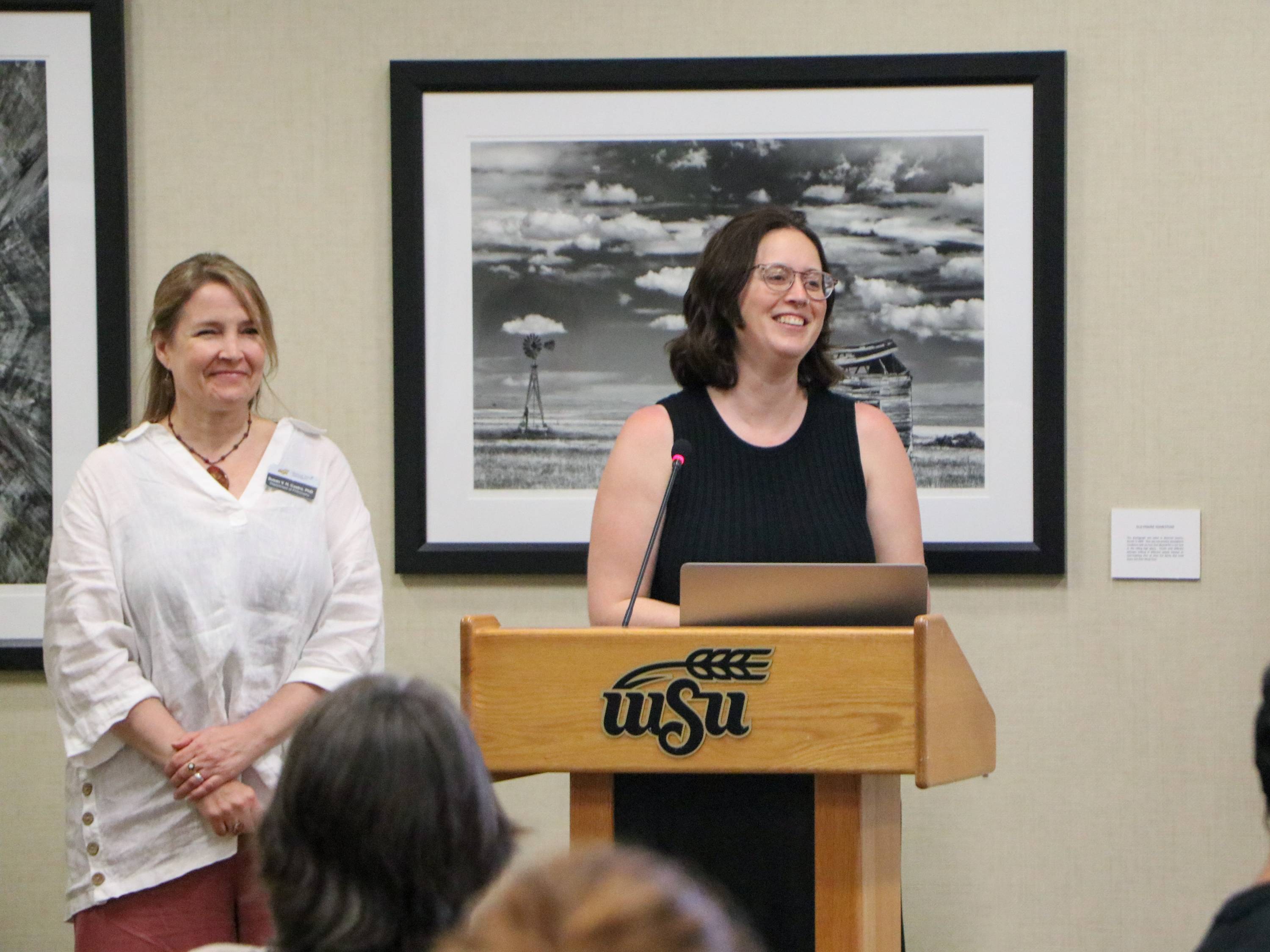 Susan Castro and Alyssa Lynne-Joseph explani their project at the Mutual Mentoring Awards.