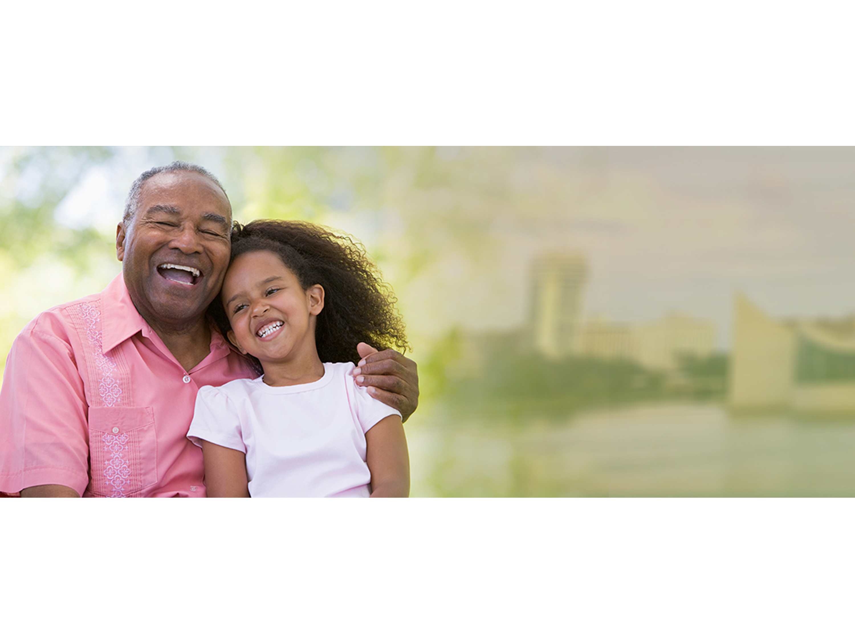 A grandfather and granddaughter smiling together