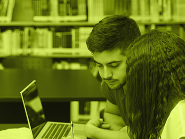 Two students looking at a computer