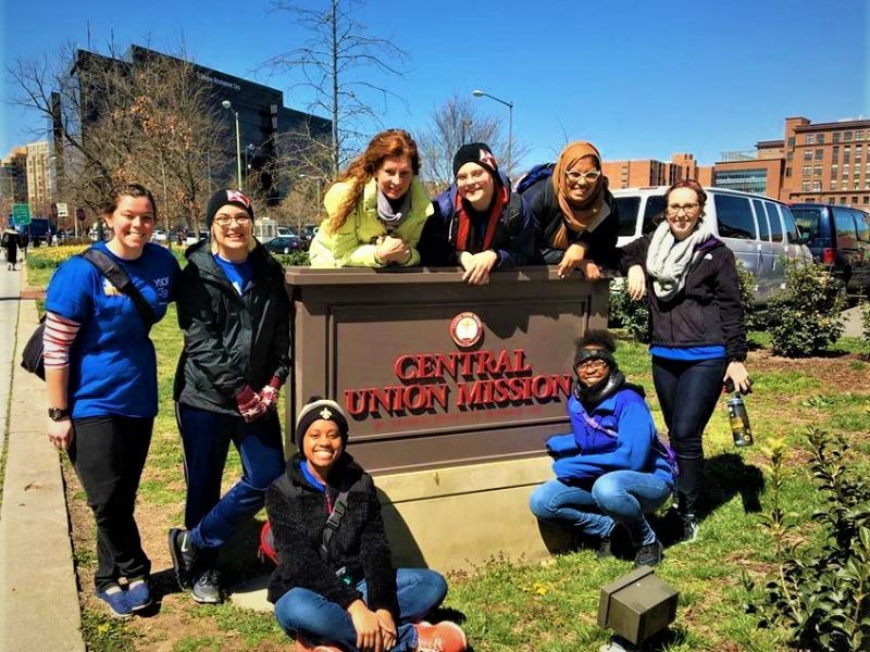 Students infront of Sign